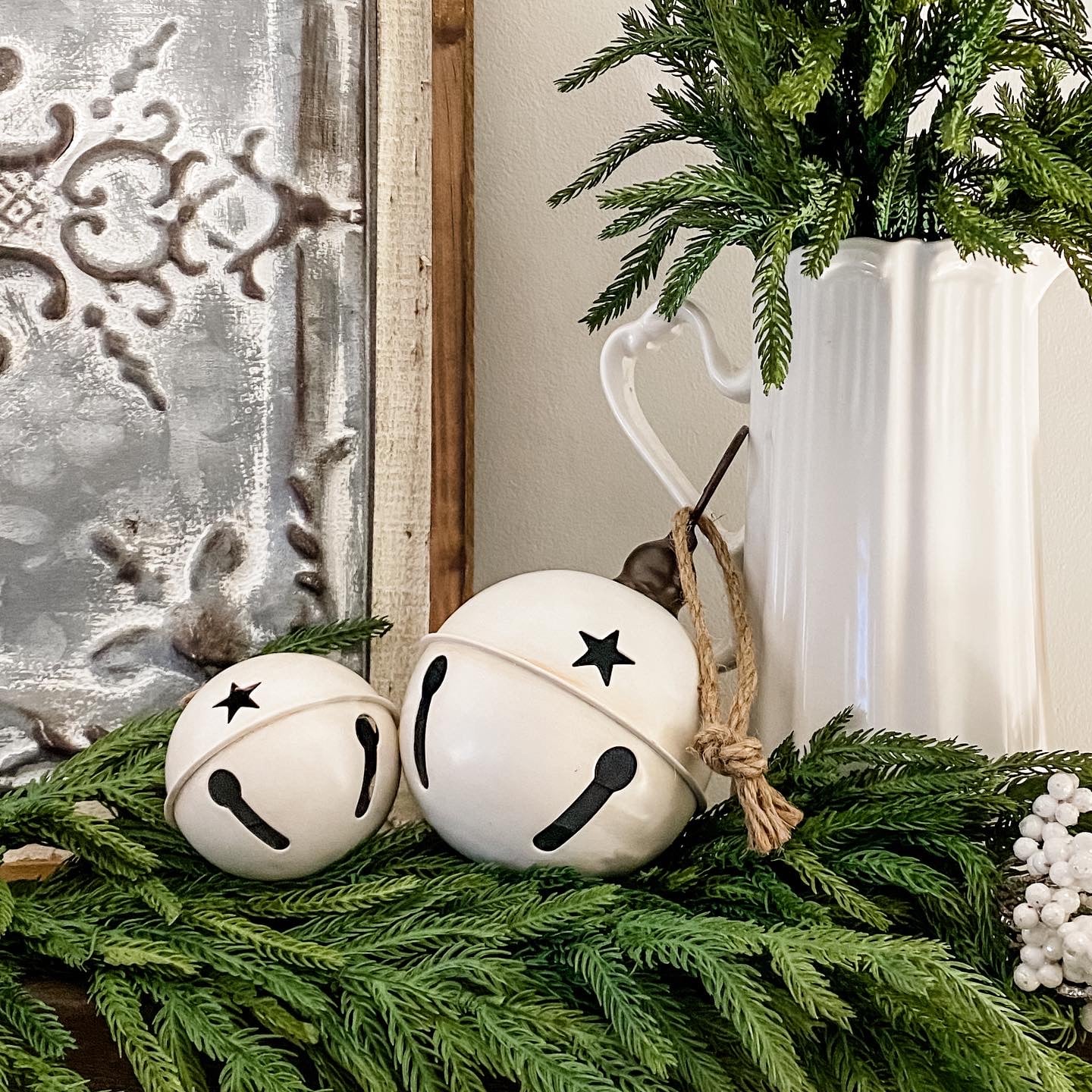 Large metal sleigh bells in creamy-white tones with loop for hanging